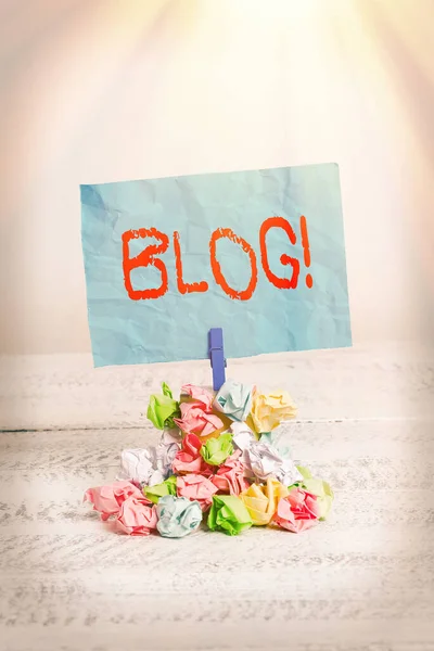 Conceptual hand writing showing Blog. Business photo showcasing regularly updated website or web page run by an individual or group Reminder pile colored crumpled paper clothespin wooden space.