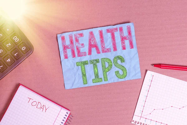 Text sign showing Health Tips. Conceptual photo advice or information given to be helpful in being healthy Cardboard paperboard notebook office study supplies chart reminder paper.