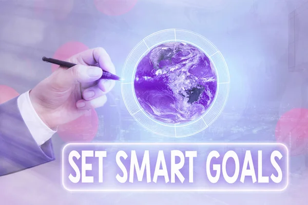 Conceptual hand writing showing Set Smart Goals. Business photo text list to clarify your ideas focus efforts use time wisely Elements of this image furnished by NASA.