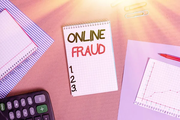 Text sign showing Online Fraud. Conceptual photo use of Internet services to deceive victims and steal money Striped paperboard notebook cardboard office study supplies chart paper.