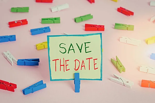 Text sign showing Save The Date. Conceptual photo Organizing events well make day special event organizers Colored clothespin papers empty reminder pink floor background office pin. — Stock Photo, Image