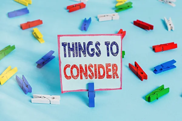 Text sign showing Things To Consider. Conceptual photo think about something carefully in order to make decision Colored clothespin papers empty reminder blue floor background office pin. — Stock Photo, Image