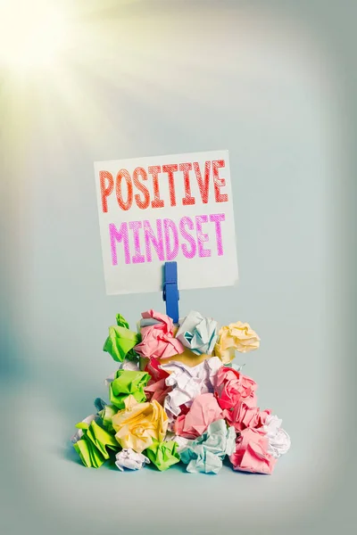 Writing note showing Positive Mindset. Business photo showcasing mental attitude in wich you expect favorable results Reminder pile colored crumpled paper clothespin wooden space.