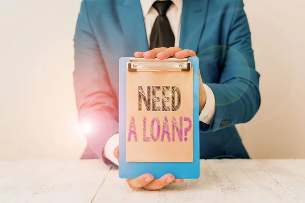 Conceptual hand writing showing Need A Loan Question. Business photo text asking he need money expected paid back with interest Man holds empty paper with copy space in front of him Space. — Stock Photo, Image