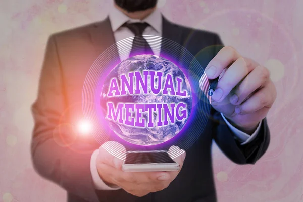 Handwriting text Annual Meeting. Concept meaning yearly meeting of the general membership of an organization Elements of this image furnished by NASA.