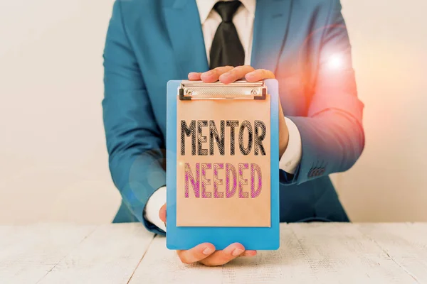 Conceptual hand writing showing Mentor Needed. Business photo text Employee training under senior assigned act as advisor Man holds empty paper with copy space in front of him Space.