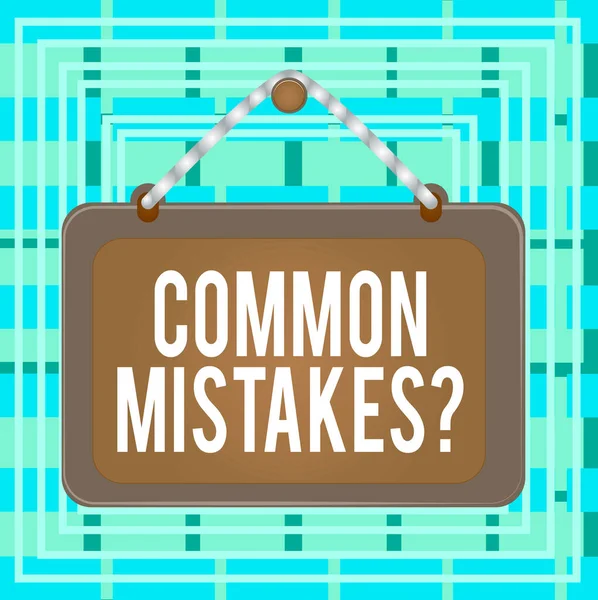 Text sign showing Common Mistakes Question. Conceptual photo repeat act or judgement misguided making something wrong Board fixed nail frame string striped colored background rectangle panel.
