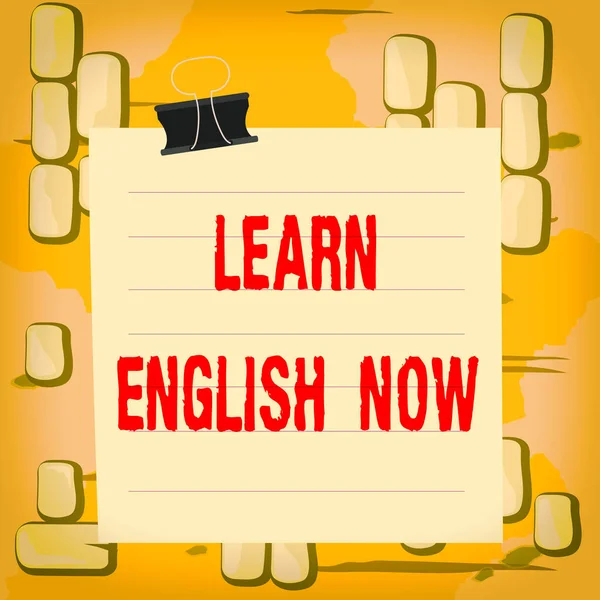 Word writing text Learn English Now. Business concept for gain or acquire knowledge and skill of english language Paper lines binder clip cardboard blank square notebook color background.