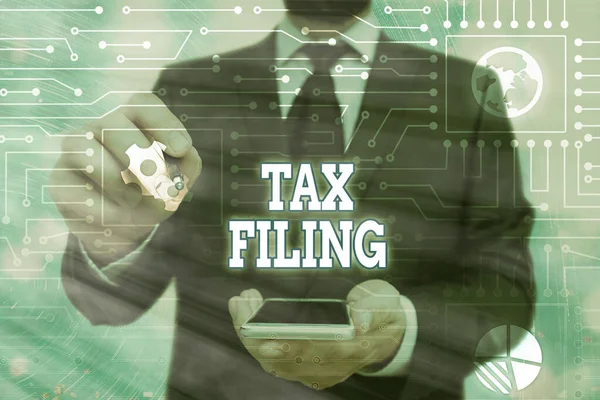 Handwriting text Tax Filing. Concept meaning Submitting documens filed with tax payer financial information.