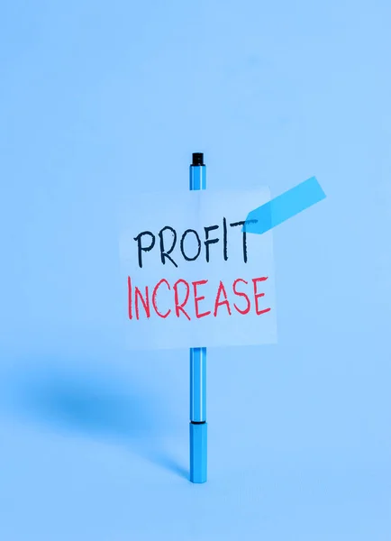 Conceptual hand writing showing Profit Increase. Business photo showcasing the growth in the amount of revenue gained from a business Ballpoint sticky note arrow banner peaceful cool background.