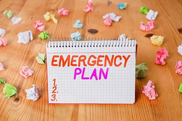 Handwriting text writing Emergency Plan. Concept meaning actions developed to mitigate damage of potential events Colored crumpled papers empty reminder wooden floor spiral notebook office. — Stock Photo, Image