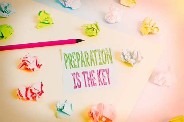 Text sign showing Preparation Is The Key. Conceptual photo it reduces errors and shortens the activities Colored crumpled papers empty reminder blue yellow background clothespin.