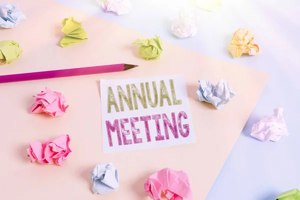 Text sign showing Annual Meeting. Conceptual photo yearly meeting of the general membership of an organization Colored crumpled papers empty reminder blue yellow background clothespin.