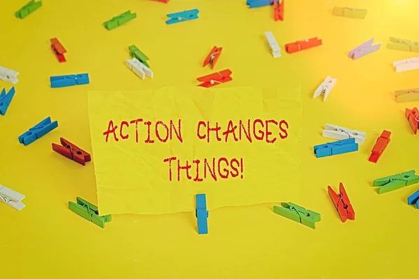 Handwriting text writing Action Changes Things. Concept meaning start doing something against problem resolve or achieve it Colored clothespin papers empty reminder yellow floor background office. — Stock Photo, Image