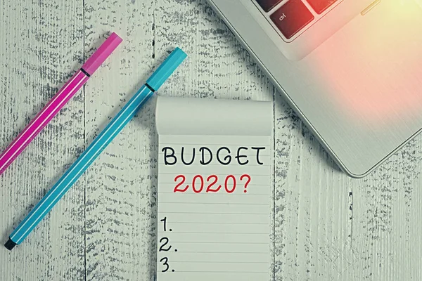 Conceptual hand writing showing Budget 2020 Question. Business photo text estimate of income and expenditure for next year Trendy laptop blank ruled notepad pens lying wooden vintage table.