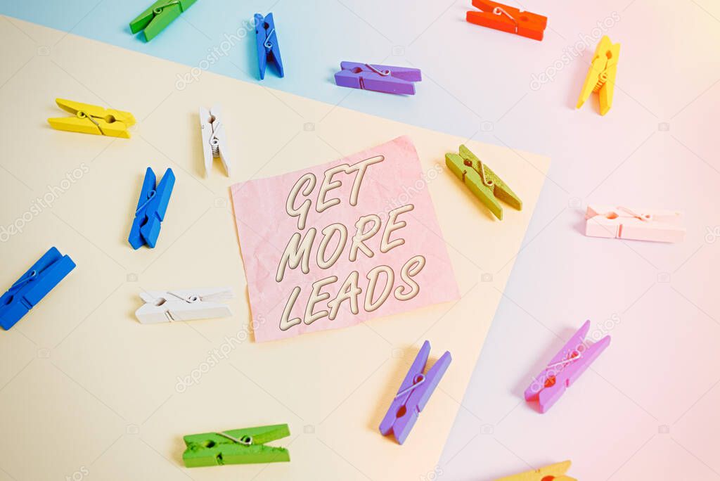 Text sign showing Get More Leads. Conceptual photo to have more customers and improve your target sales Colored clothespin paper empty reminder yellow blue floor background office.