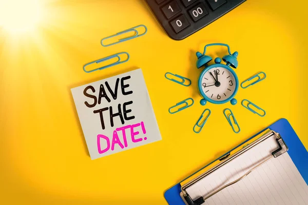 Conceptual hand writing showing Save The Date. Business photo text Organizing events well make day special event organizers Alarm clock clipboard clips calculator notepad colored background. — Stock Photo, Image