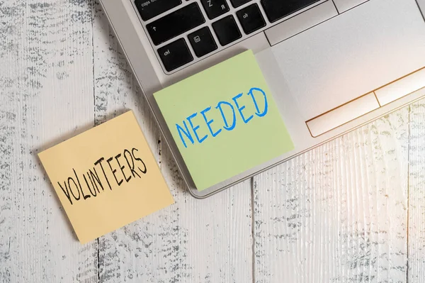 Text sign showing Volunteers Needed. Conceptual photo need work or help for organization without being paid Trendy silver metallic laptop two sticky note pads lying vintage table. — Stock Photo, Image