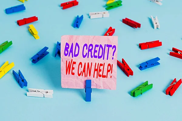 Handwriting text Bad Creditquestion We Can Help. Concept meaning offerr help to gain positive payment history Colored clothespin papers empty reminder blue floor background office pin.