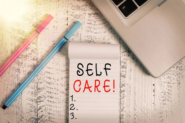 Conceptual hand writing showing Self Care. Business photo text practice of taking action preserve or improve ones own health Trendy laptop blank ruled notepad pens lying wooden vintage table. — Stock Photo, Image