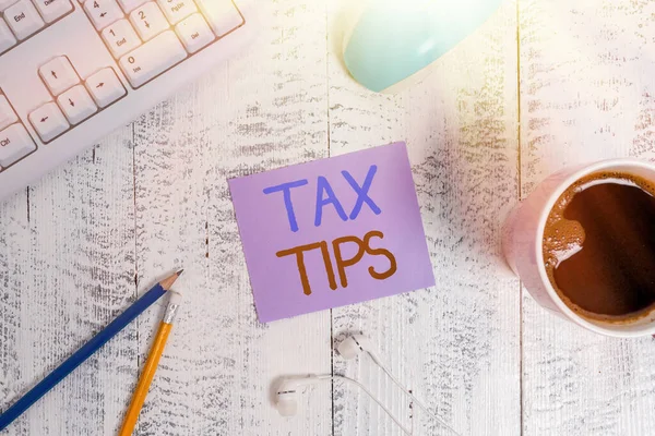 Text sign showing Tax Tips. Conceptual photo compulsory contribution to state revenue levied by government technological devices colored reminder paper office supplies keyboard mouse.