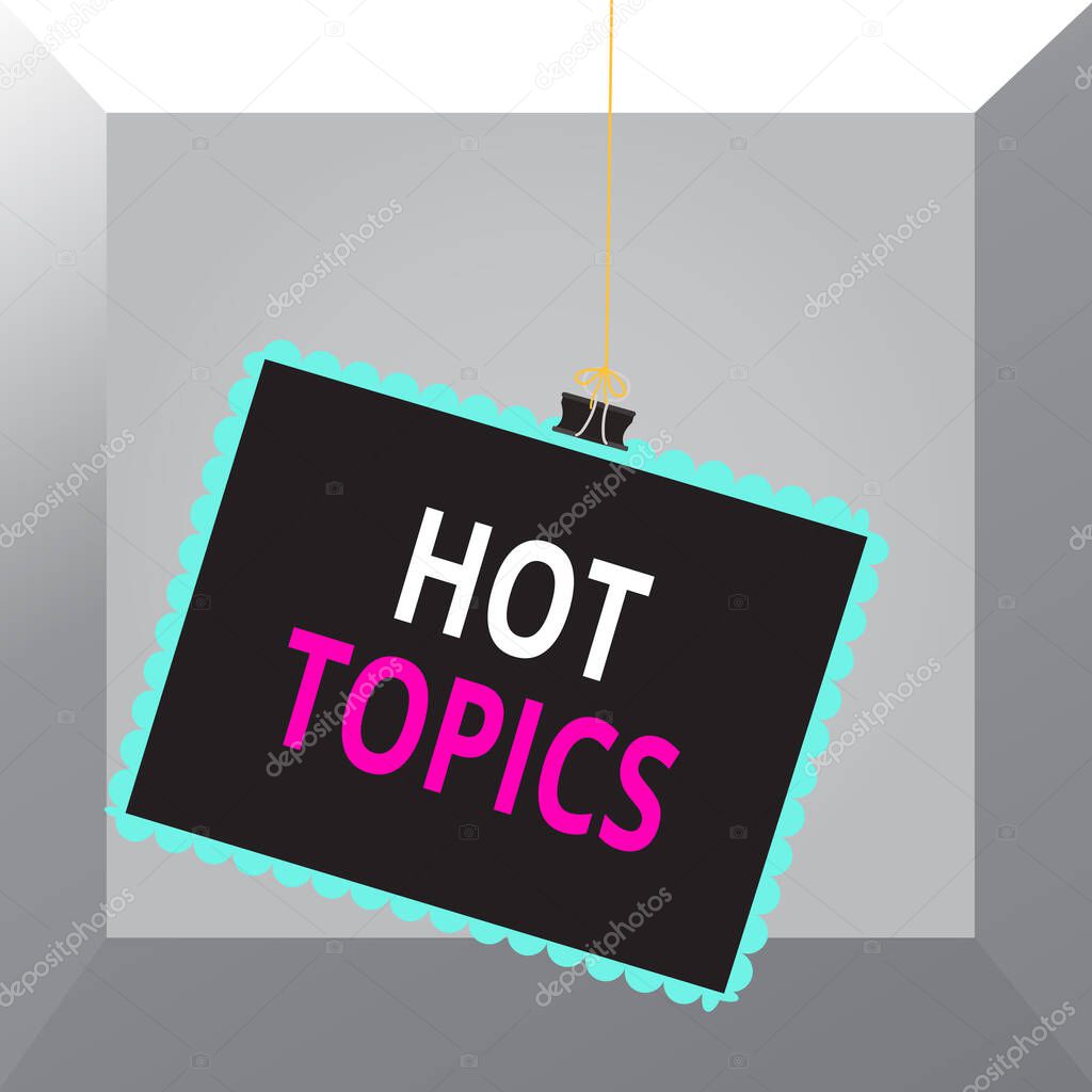 Conceptual hand writing showing Hot Topics. Business photo text subject that a lot of showing are arguing and discussing Stamp stuck binder clip square color frame rounded tip.