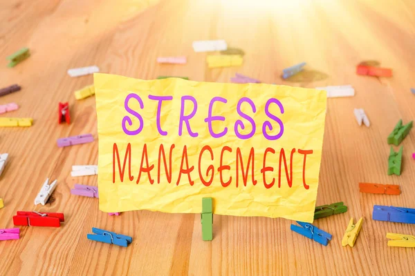 Writing note showing Stress Management. Business photo showcasing method of limiting stress and its effects by learning ways Colored clothespin papers empty reminder wooden floor background office.