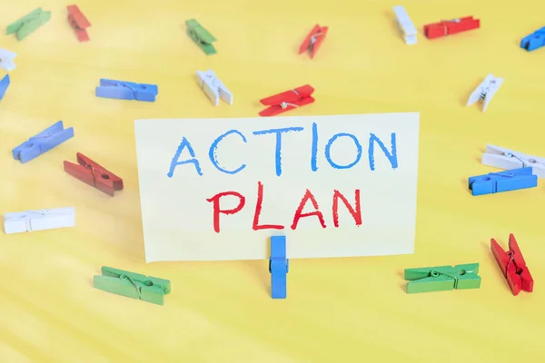 Word writing text Action Plan. Business concept for detailed plan outlining actions needed to reach goals or vision Colored clothespin papers empty reminder yellow floor background office.