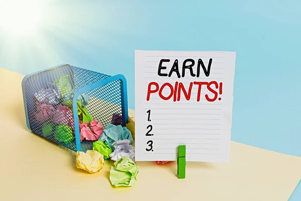 Conceptual hand writing showing Earn Points. Business photo showcasing collecting scores in order qualify to win big prize Trash bin crumpled paper clothespin reminder office supplies.