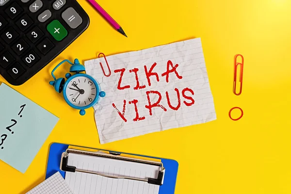 Word writing text Zika Virus. Business concept for caused by a virus transmitted primarily by Aedes mosquitoes Clock clips crushed note calculator pencil clipboard band color background.