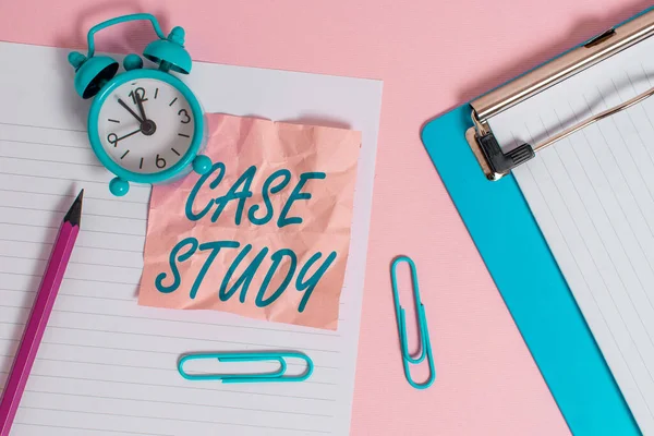 Text sign showing Case Study. Conceptual photo analysis and a specific research design for examining a problem Paper sheet note clipboard pencil clips alarm clock colored background.