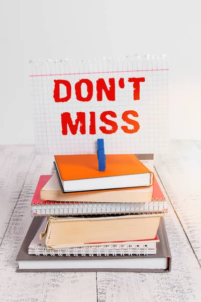 Writing note showing Don T Miss. Business photo showcasing commanding them not to miss out an opportunity or an advantage pile stacked books notebook pin color reminder white wooden.