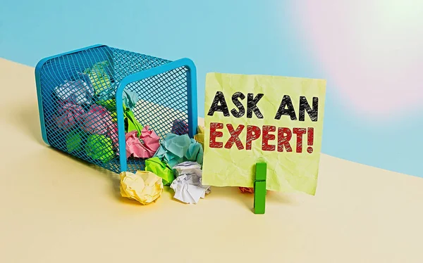 Writing note showing Ask An Expert. Business photo showcasing consult someone who has skill about something or knowledgeable Trash bin crumpled paper clothespin reminder office supplies. — Stock Photo, Image