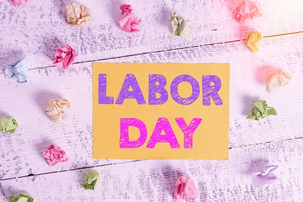 Conceptual hand writing showing Labor Day. Business photo showcasing an annual holiday to celebrate the achievements of workers Crumpled rectangle squared paper reminder white wood desk.