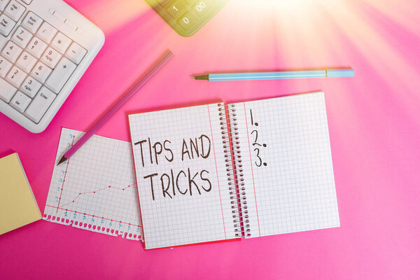 Text sign showing Tips And Tricks. Conceptual photo piece of inside facts specially in betting or investing Writing equipments and computer stuffs placed above classic wooden table.