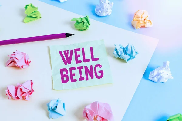 Writing note showing Well Being. Business photo showcasing A good or satisfactory condition of existence including health Colored crumpled papers empty reminder blue yellow clothespin.