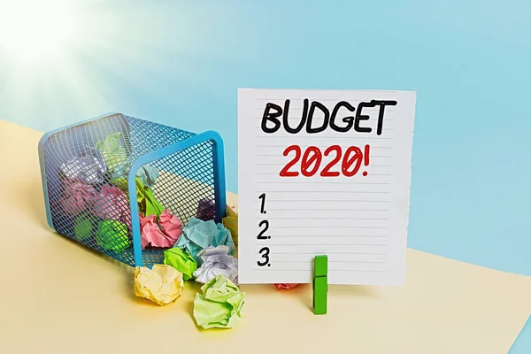 Conceptual hand writing showing Budget 2020. Business photo showcasing estimate of income and expenditure for current year Trash bin crumpled paper clothespin reminder office supplies.