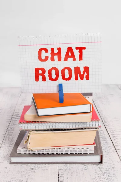 Writing note showing Chat Room. Business photo showcasing area on the Internet or computer network where users communicate pile stacked books notebook pin color reminder white wooden.