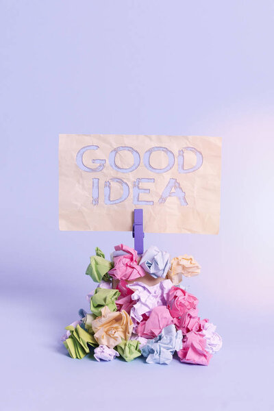 Handwriting text writing Good Idea. Concept meaning an excellent suggestion and plan for achieving something Reminder pile colored crumpled paper clothespin reminder blue background.