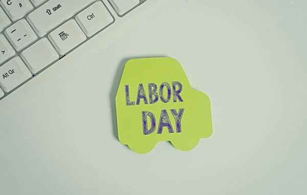 Word writing text Labor Day. Business concept for an annual holiday to celebrate the achievements of workers Green note paper in the shape of the car. Copy space on the green note paper.