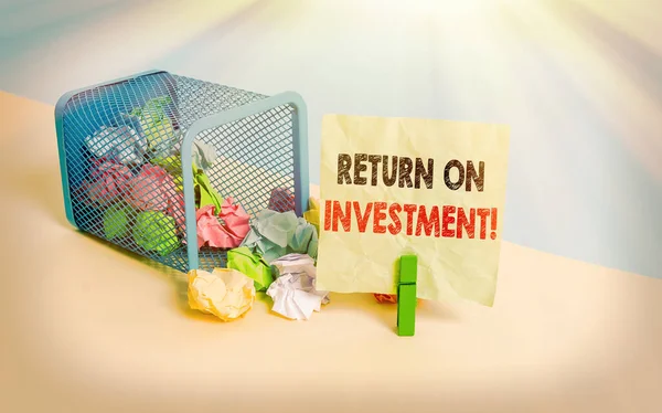 Writing note showing Return On Investment. Business photo showcasing performance measure used evaluate efficiency of investment Trash bin crumpled paper clothespin reminder office supplies.