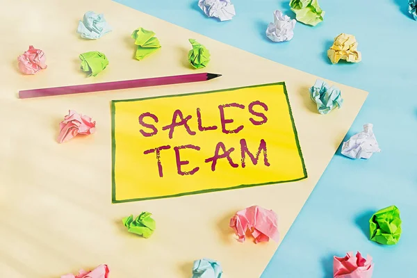 Writing note showing Sales Team. Business photo showcasing they are responsible for of selling products or services Colored crumpled papers empty reminder blue yellow clothespin.