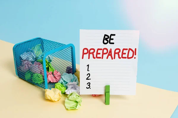 Conceptual hand writing showing Be Prepared. Business photo showcasing try be always ready to do or deal with something Trash bin crumpled paper clothespin reminder office supplies.