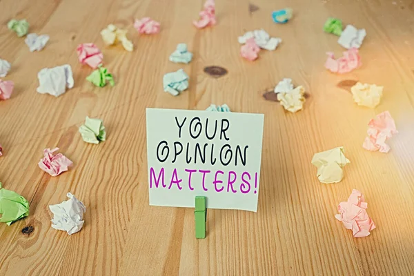 Handwriting text Your Opinion Matters. Concept meaning show you do not agree with something that just been said Colored crumpled papers empty reminder wooden floor background clothespin.