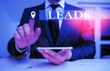 Handwriting text Leads. Concept meaning route or means of access to particular place Facebook ad campaign Male human wear formal clothes present presentation use hi tech smartphone.