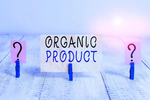 Writing note showing Organic Product. Business photo showcasing made from materials produced by organic agriculture Crumbling sheet with paper clips placed on the wooden table.