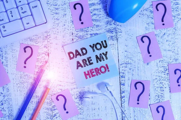 Conceptual hand writing showing Dad You Are My Hero. Business photo showcasing Admiration for your father love feelings compliment Writing tools and scribbled paper on top of the wooden table. — Stock Photo, Image