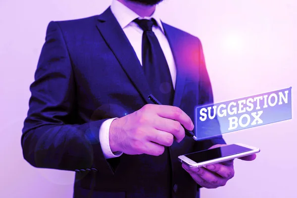 Text sign showing Suggestion Box. Conceptual photo container which showing can leave comments about something Male human wear formal work suit hold smart hi tech smartphone use one hand.