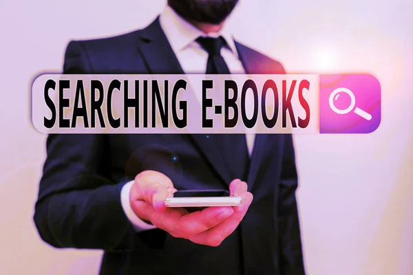 Writing note showing Searching E Books. Business photo showcasing looking for an electronic form of educational material Male human wear formal work suit hold smartphone using hand. — Stock Photo, Image