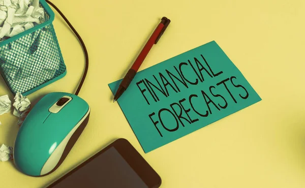 Conceptual hand writing showing Financial Forecasts. Business photo text estimate of future financial outcomes for a company crumpled paper in bin placed next to modern gadget and stationary.